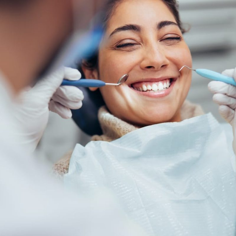 Over,The,Shoulder,View,Of,A,Dentist,Examining,A,Patients Over,The,Shoulder,View,Of,A,Dentist,Examining,A,Patients